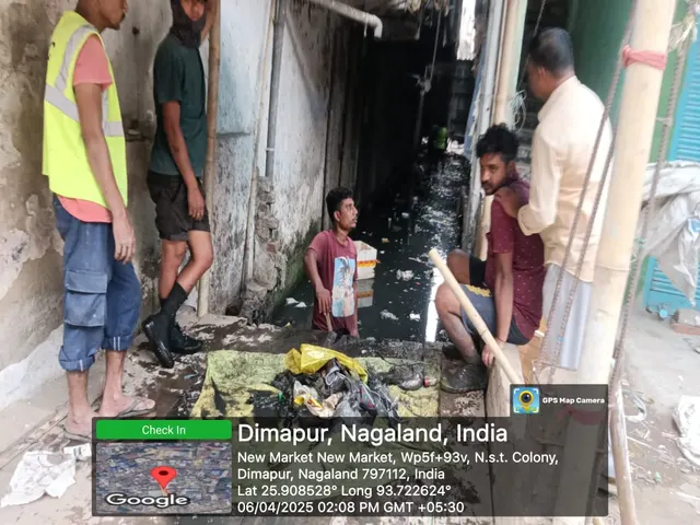 Workers and an official at a drain cleaning in a market lane